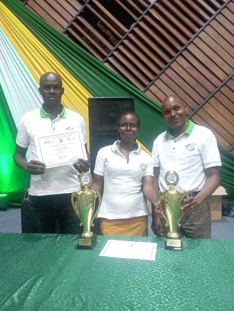 Unga Sacco members celebrating with trophies